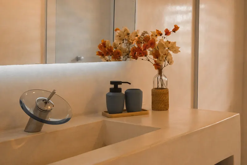 Stylish and minimalist bathroom counter setup with elegant floral decor and modern faucet design